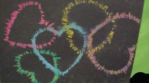 Chalk pastels on black construction paper, using heart shaped cut-outs.